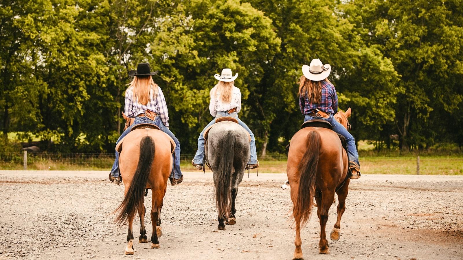 three horse riders